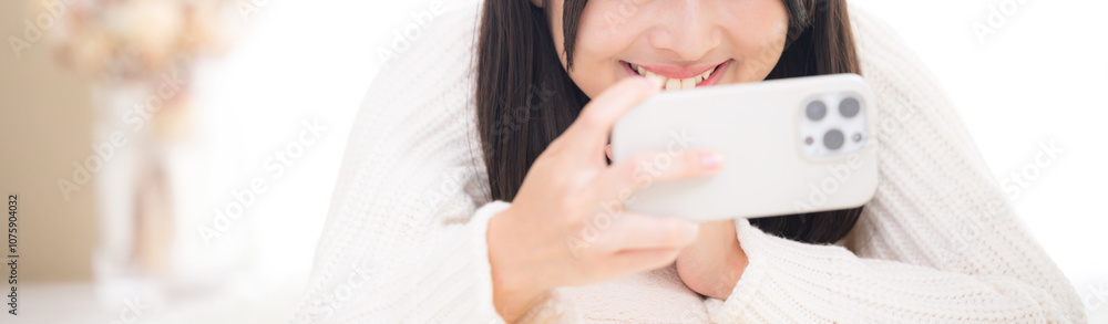 Banner of a close-up of a young woman lying on her back and looking at her phone