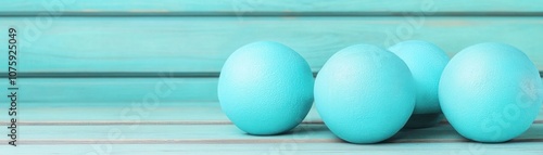 Beautiful turquoise eggs arranged on a wooden surface, showcasing a vibrant pastel color scheme perfect for spring celebrations and festive decorations.