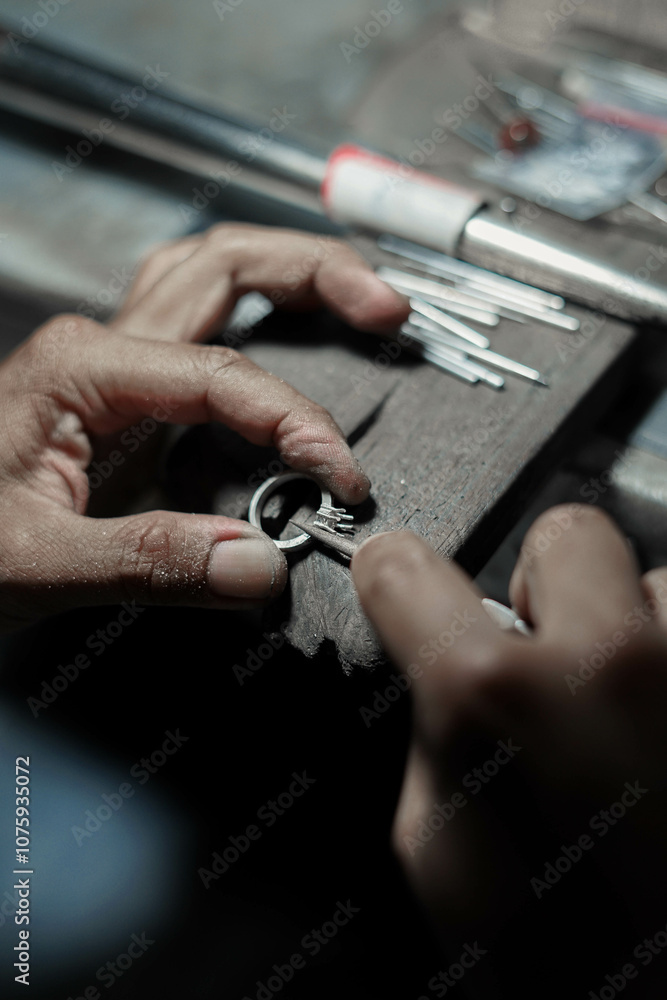 Goldsmith's hand making a white gold ring, Goldsmith's hand making a white gold ring,