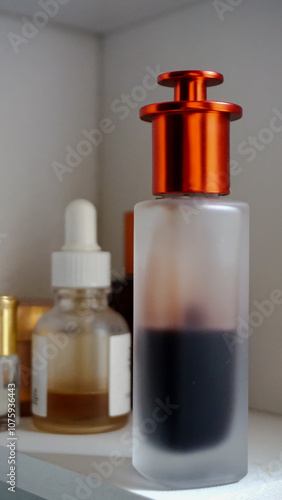 Close-Up of amber glass bottle with Orange cap.