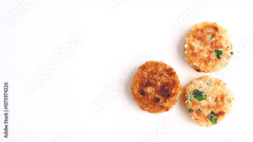 Three golden-brown, crispy snacks with green flecks, arranged on a white background. Perfect for appetizers or a light snack.