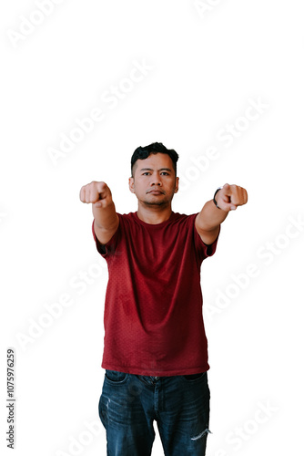 ortrait of a serious man in a red t-shirt and jeans, with both arms extended forward in a fist gesture photo