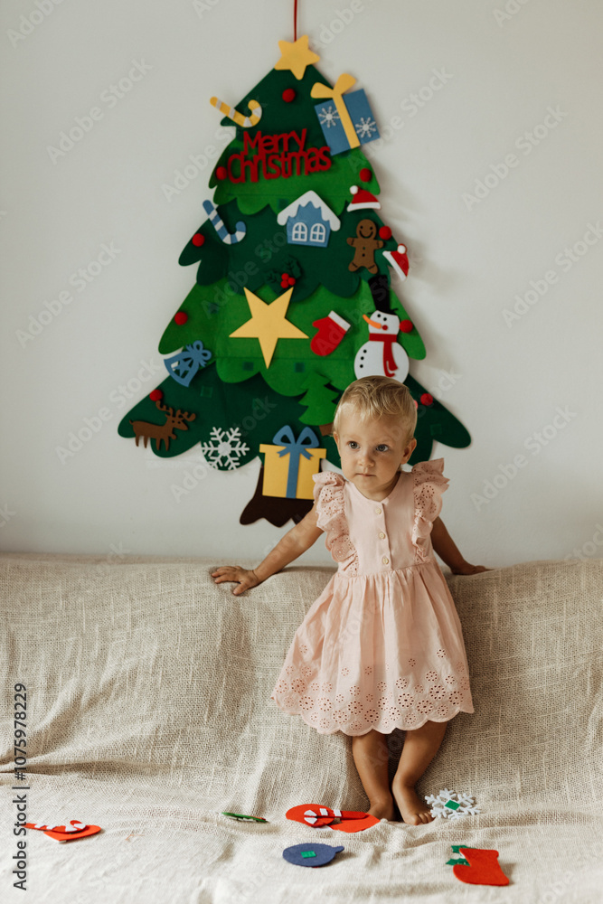 Making of handmade christmas tree from felt with your own hands. Children's DIY concept. Making xmas toys decoration or greeting card and decoarate christmas tree hanging on the  wall