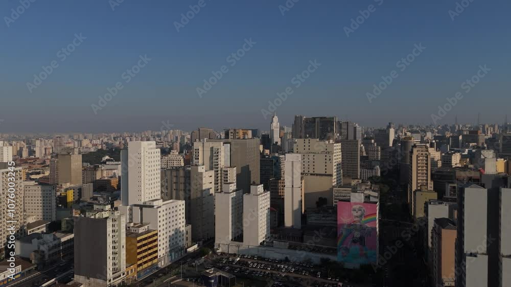 Aerial view of São Paulo's dense skyline under a clear blue sky, with the São Paulo state flag prominently displayed. High-rise buildings showcase the city's urban density and modern architecture Aerial view of São Paulo's dense skyline under a clear blue sky, with the São Paulo state flag prominently displayed. High-rise buildings showcase the city's urban density and modern architecture