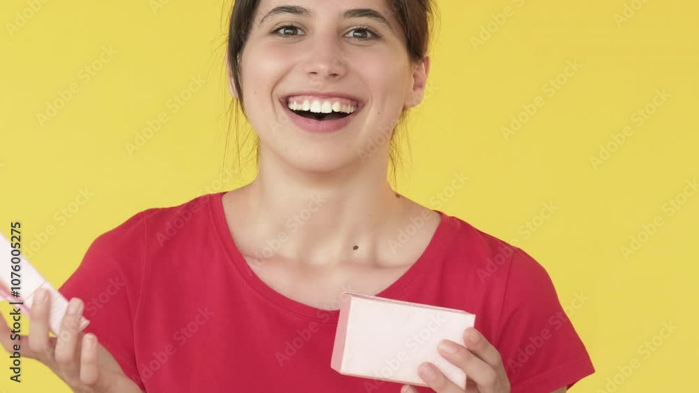 Unexpected gift. Woman receiving present. Dream fulfillment happy joyful with box isolated on yellow free space background. Unexpected gift. Woman receiving present. Dream fulfillment happy joyful with box isolated on yellow free space background.