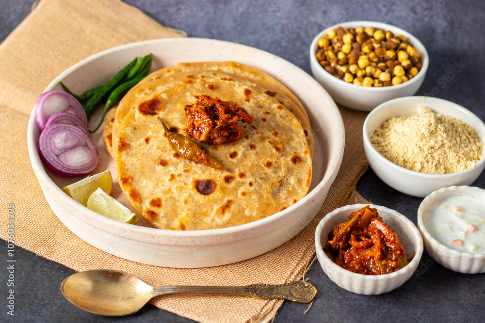 Sattu paratha, a stuffed flatbread from Uttar Pradesh and Bihar, is filled with spiced roasted gram flour and served with pickle and raita. Sattu paratha, a stuffed flatbread from Uttar Pradesh and Bihar, is filled with spiced roasted gram flour and served with pickle and raita.