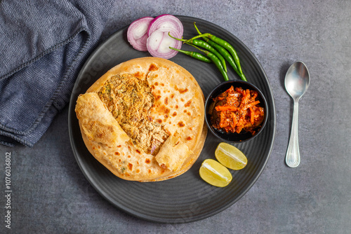 Sattu paratha is a popular stuffed flatbread from Uttar Pradesh and Bihar, served with tangy pickle and cooling raita.