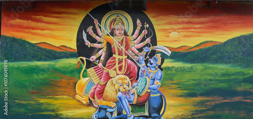 An artistically Mural color painting of Goddess Durga or Chamundi killing the Demon on the walls of a Hindu Shiva temple in Mysuru, India. photo