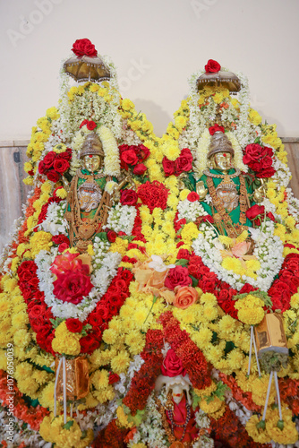 Gold colored Idols of Goddess Padmavati and Jwalamala divinely decorated with floral garlands at a Hindu Jain temple in Mysuru, India. photo