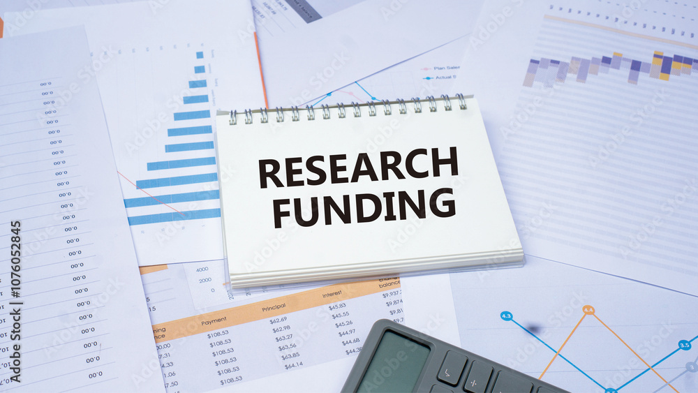 RESEACRH FUNDING word. Concept word on notes with diagram charts and calculator. Idea for healthcare, typography, medical, business and financial concept. Copy space RESEACRH FUNDING word. Concept word on notes with diagram charts and calculator. Idea for healthcare, typography, medical, business and financial concept. Copy space