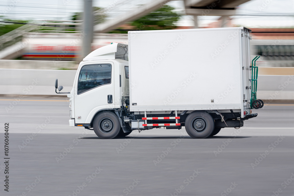 Side view of a small truck driving on a city road, truck running on the road, small truck on the road. Side view of a small truck driving on a city road, truck running on the road, small truck on the road.