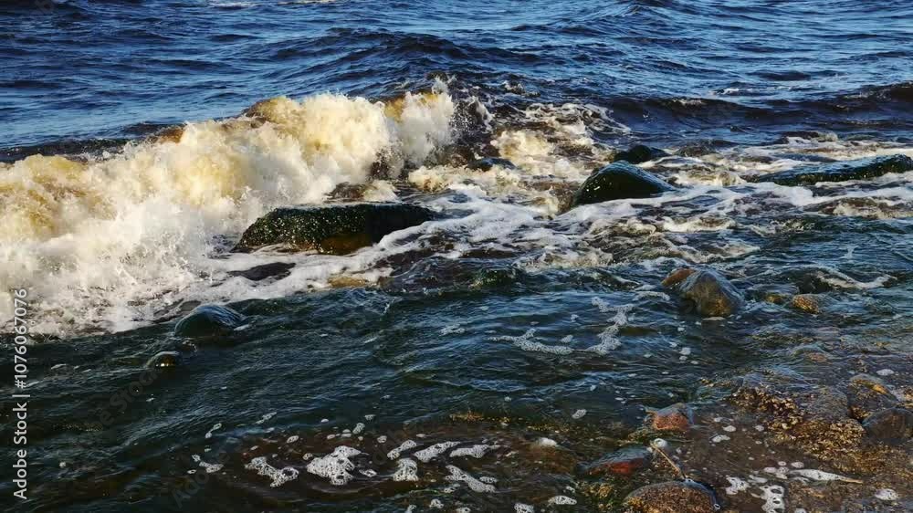 Waves meet rocky shore in a calming spring scene, adding dynamic coastal beauty Waves meet rocky shore in a calming spring scene, adding dynamic coastal beauty