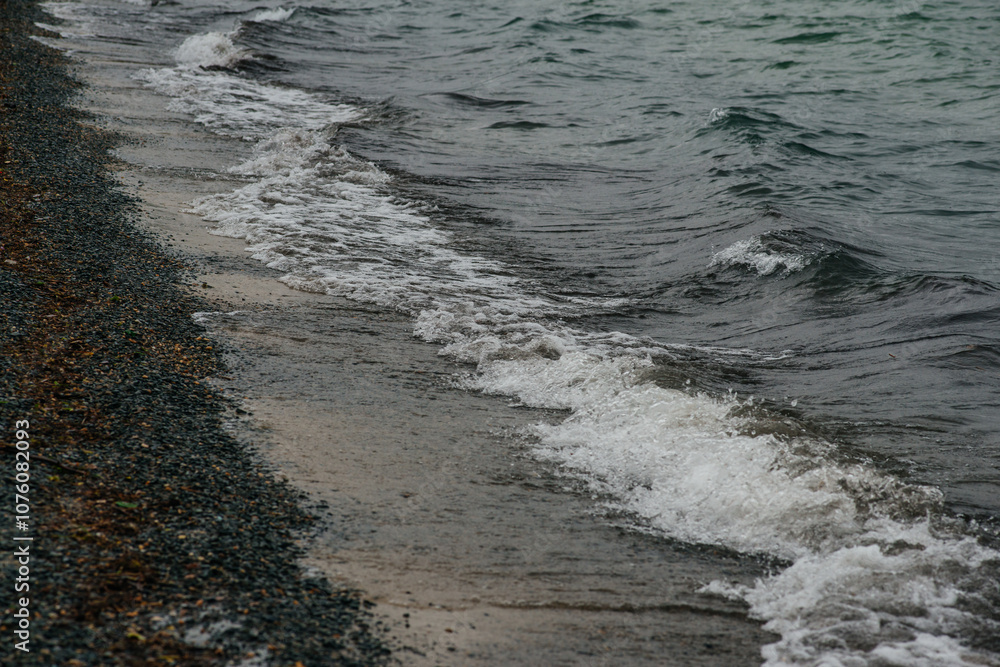 big waves near the shore with pebbles big waves near the shore with pebbles