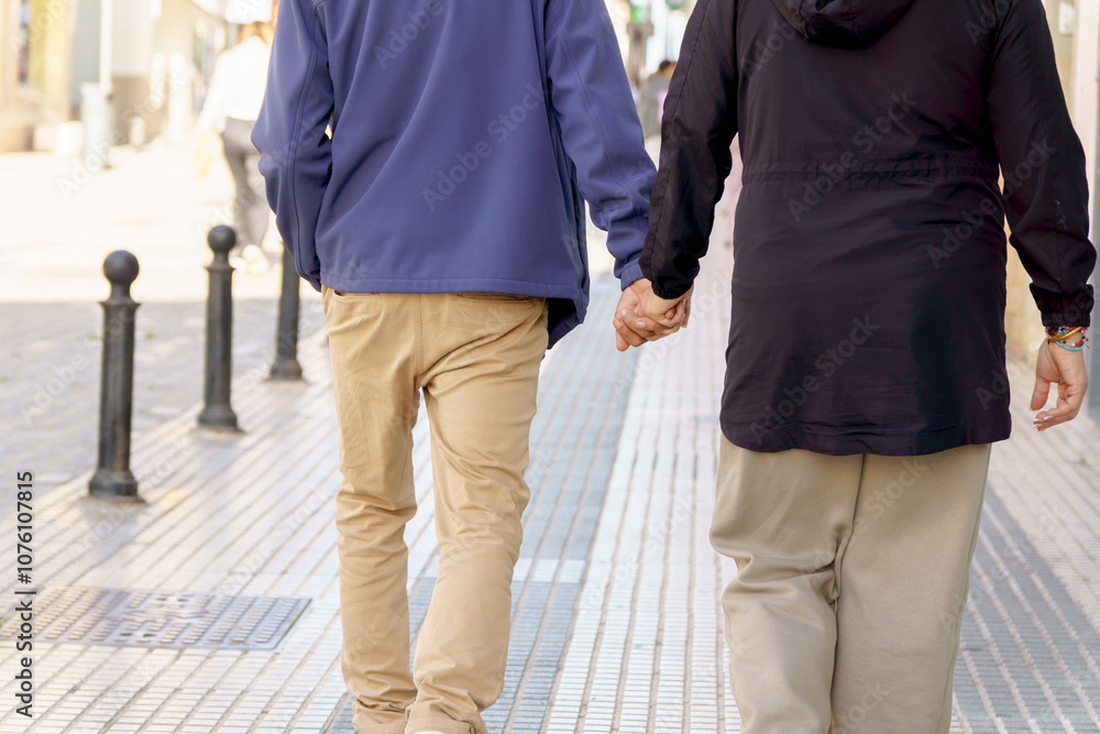 couple strolling hand in hand along a pedestrian street couple strolling hand in hand along a pedestrian street
