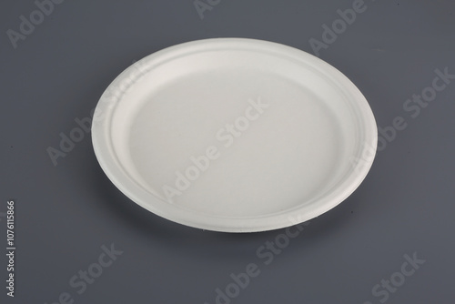 Biodegradable disposable tableware plates, glasses and spoons with forks on close-up Trend ecology plastic free photo