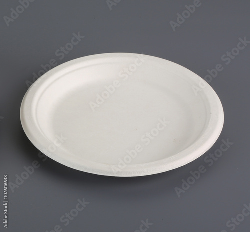 Natural eco-friendly disposable utensils (fork, spoon, dish plate, bowl, cup and fast food box container) made of fiber of bagasse and bamboo on wooden table with white wall background. Save the earth