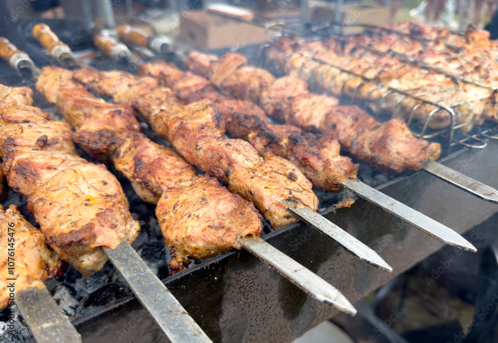 A plate of meat is being cooked on a grill A plate of meat is being cooked on a grill