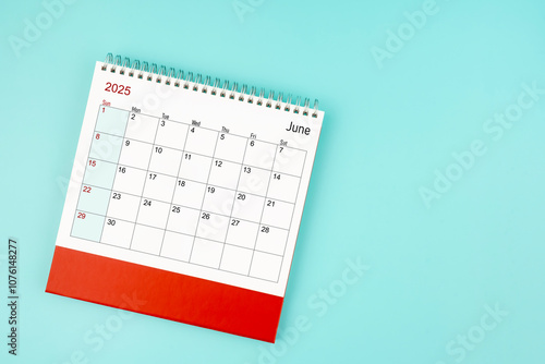 June 2025 desk calendar on blue background for your appointment. photo