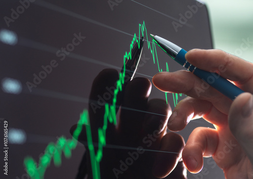 City analyst viewing share price performance on a touch screen photo