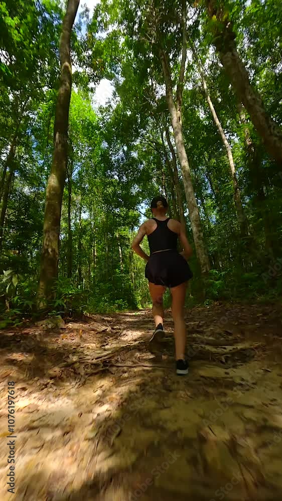 Caucasian athletic woman running in tropical rainforest in Thailand Caucasian athletic woman running in tropical rainforest in Thailand