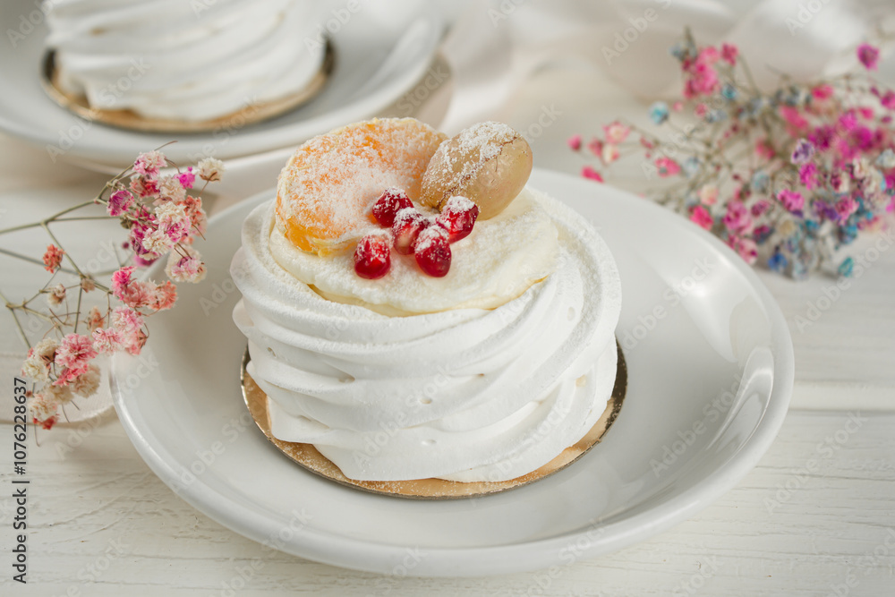 Meringue dessert with fruits. White dessert on a light table. Meringue dessert with fruits. White dessert on a light table.