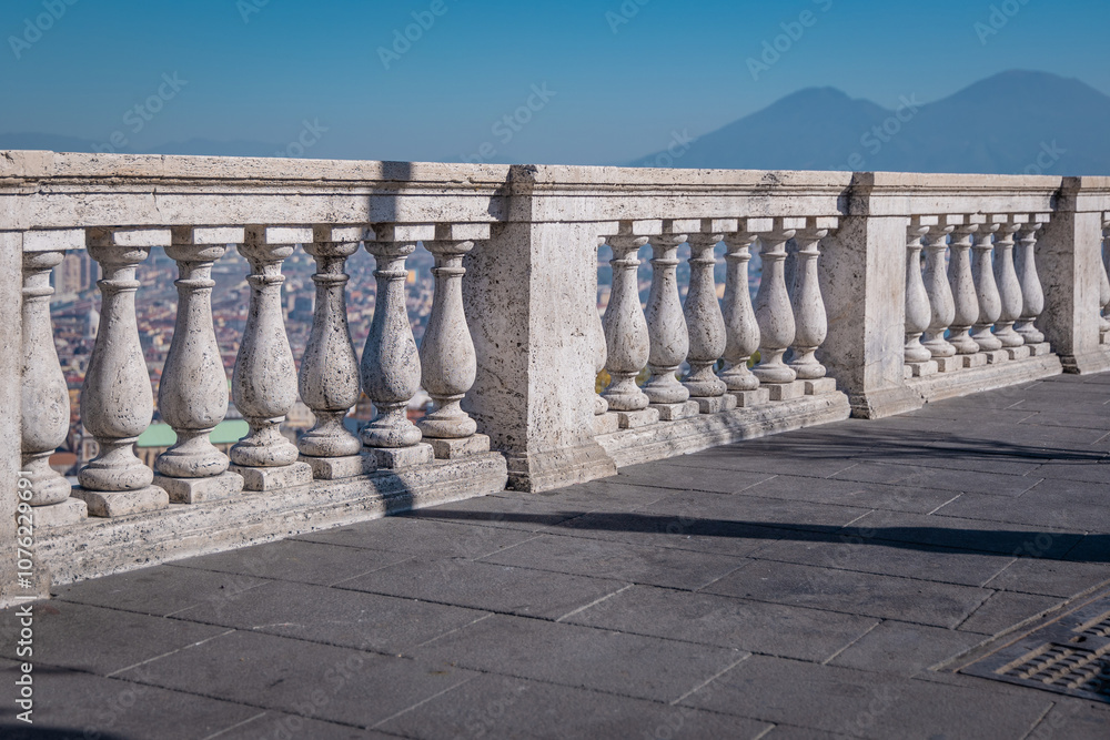 Fototapeta premium Concrete fence or marble wall overlooking the city of Napoli on a sunny summer or autumn day. Typical marble pillars above the city of Naples at the saint elmo fortress...