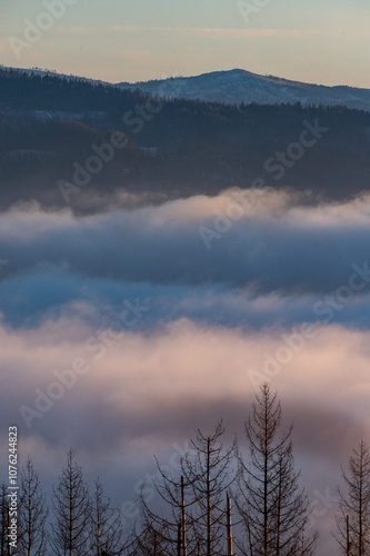 Panorama of mountain peaks above inversion with sunrise and morning frost in Beskydy mountains in the Czech Republic