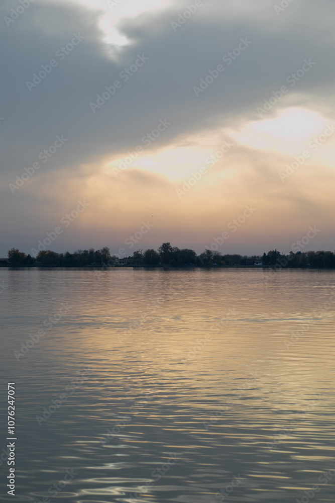 Tranquil sunset over a calm lake captures serenity and reflection, ideal for relaxation and mindfulness concepts Tranquil sunset over a calm lake captures serenity and reflection, ideal for relaxation and mindfulness concepts
