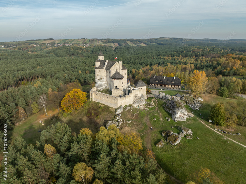 Naklejka premium Aerial drone view of Bobolice Castle in autumn.Old medieval fortress, royal castle in the village of Bobolice, Poland.Strongholds Eagles Nests in Polish Jurassic Highland.Limestone rock castle ruins.