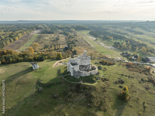 Aerial drone view of Mirow Castle in autumn. Jurassic limstone rocks on Eagles Nests in Polish Jurassic Highland. Old medieval fortress, royal castle in the village of Mirow, Poland. photo