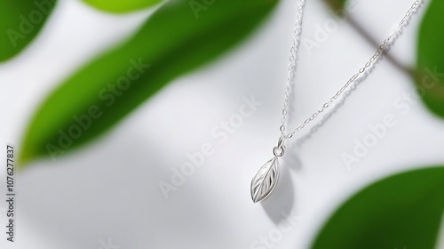 Silver Leaf Necklace with Green Background photo