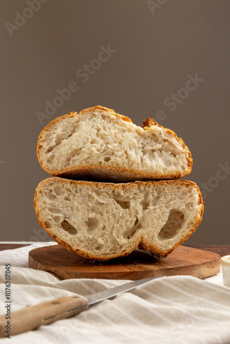 Slice of sourdough bread held by hand against backdrop