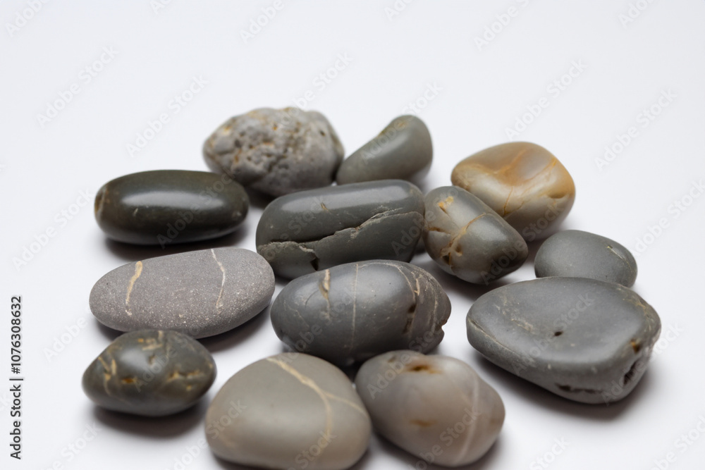 Closeup handful small gray stones lying on white. design nature concept. closeup of handful of small gray stones lying on a white. a closeup of a small handful of stones lying on a white lifestyle. Closeup handful small gray stones lying on white. design nature concept. closeup of handful of small gray stones lying on a white. a closeup of a small handful of stones lying on a white lifestyle.