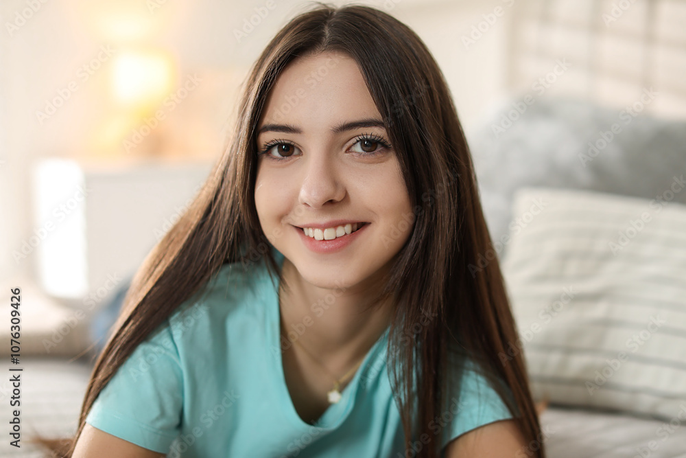 Portrait of smiling teenage girl on bed at home Portrait of smiling teenage girl on bed at home