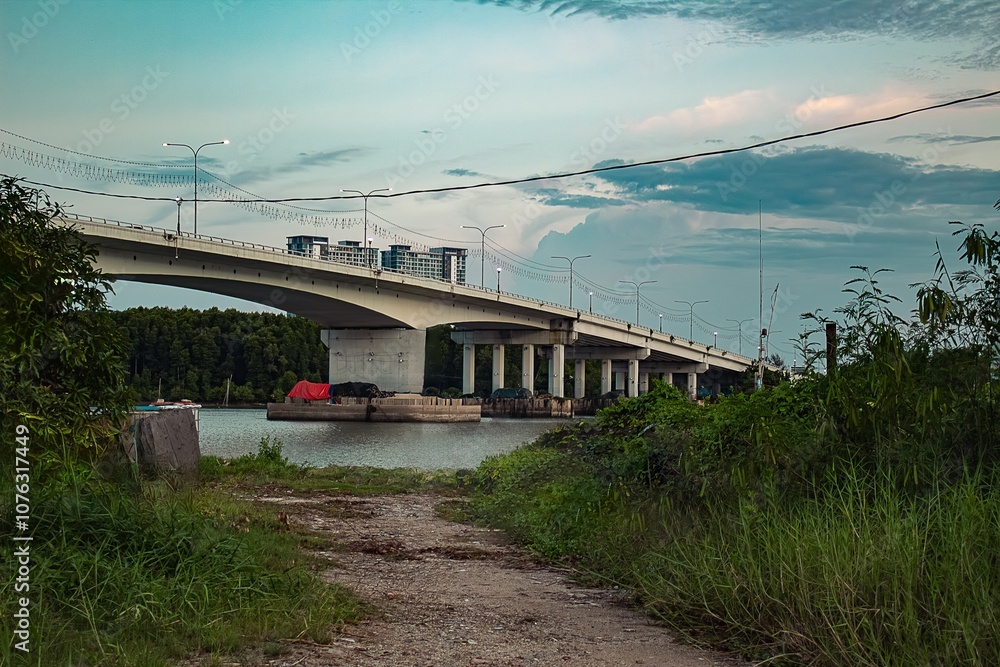 Kuantan, Tajung lumpur bridge. The Riverside of kuantan downtown. The cold water of the river flows asymmetrical of the kuantan's Bridge. Sunset windy november morning. Malaysia Kuantan, Tajung lumpur bridge. The Riverside of kuantan downtown. The cold water of the river flows asymmetrical of the kuantan's Bridge. Sunset windy november morning. Malaysia