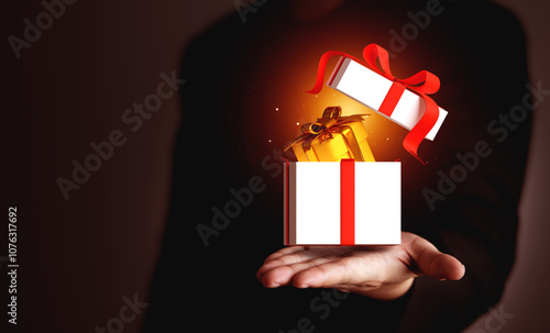 Businessman showing gift box on hand with copy space. Business concepts, annual bonuses, employee benefits, company gift exchange, and No Gift Policy
