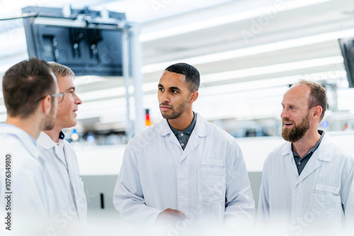Wallpaper Mural Technicians in lab coats discussing in electronics factory Torontodigital.ca
