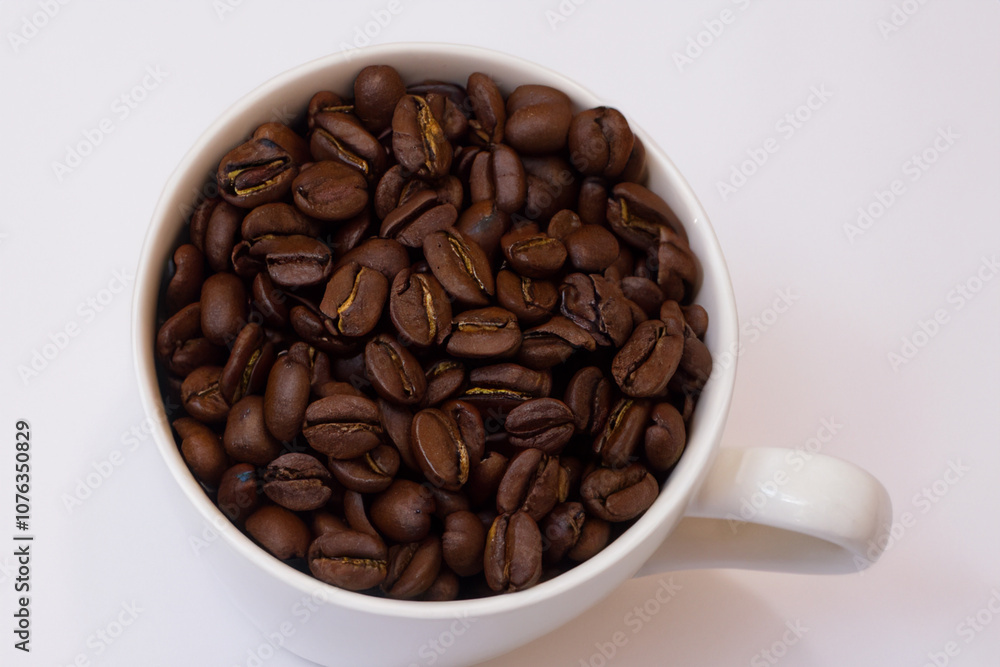 Cup of coffee on white . beverage drink concept. white cup of coffee with green beans stands on a white . a man standing on a white with a cup of coffee lifestyle and beans. Cup of coffee on white . beverage drink concept. white cup of coffee with green beans stands on a white . a man standing on a white with a cup of coffee lifestyle and beans.