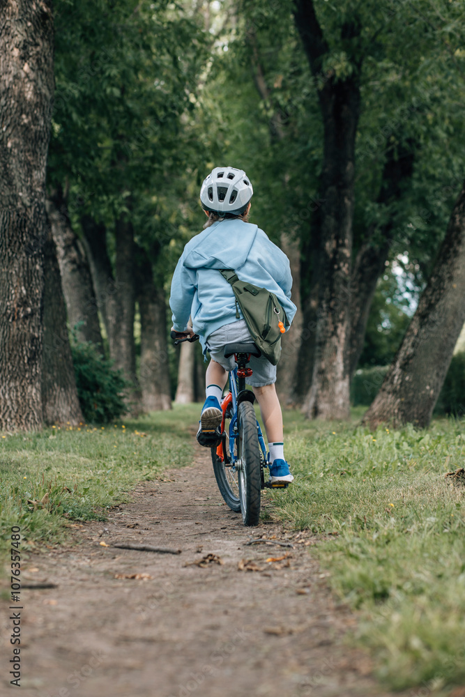 Boy with helmet riding bicycle in forest Boy with helmet riding bicycle in forest