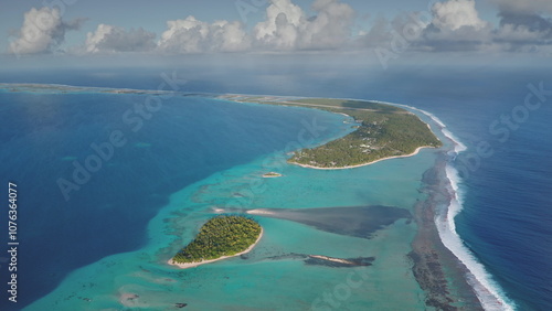 Breathtaking aerial view of Tikehau atoll, part of Palliser islands in French Polynesia, vibrant turquoise lagoon, coral reef barrier under blue sky. Remote wild nature paradise, exotic summer travel