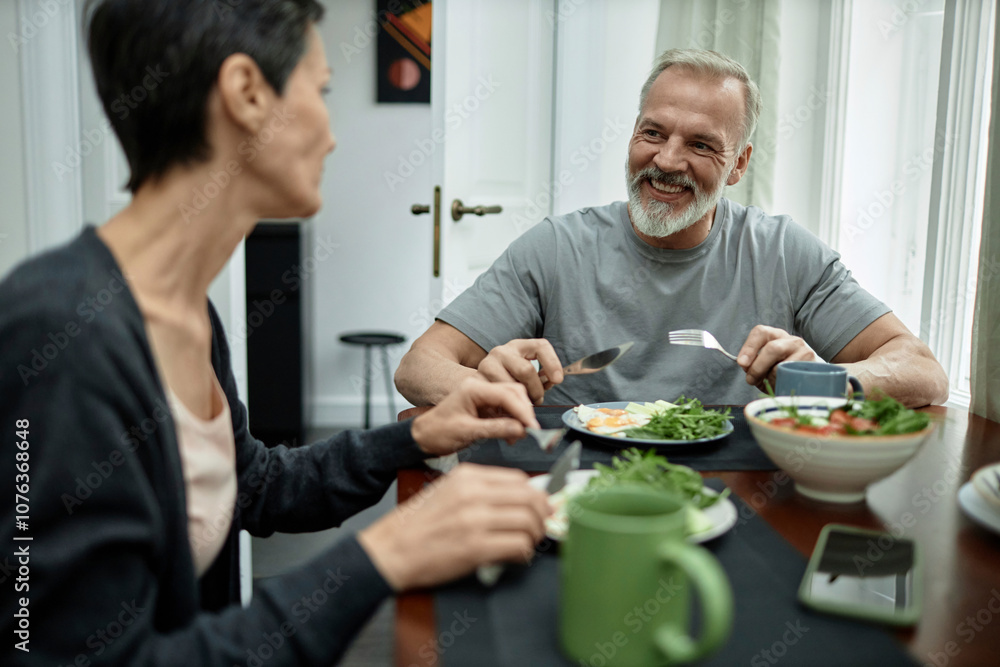 Positive husband talking to his wife during lunch at home Positive husband talking to his wife during lunch at home