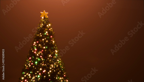 Illuminated string lights and star on Christmas tree in studio photo