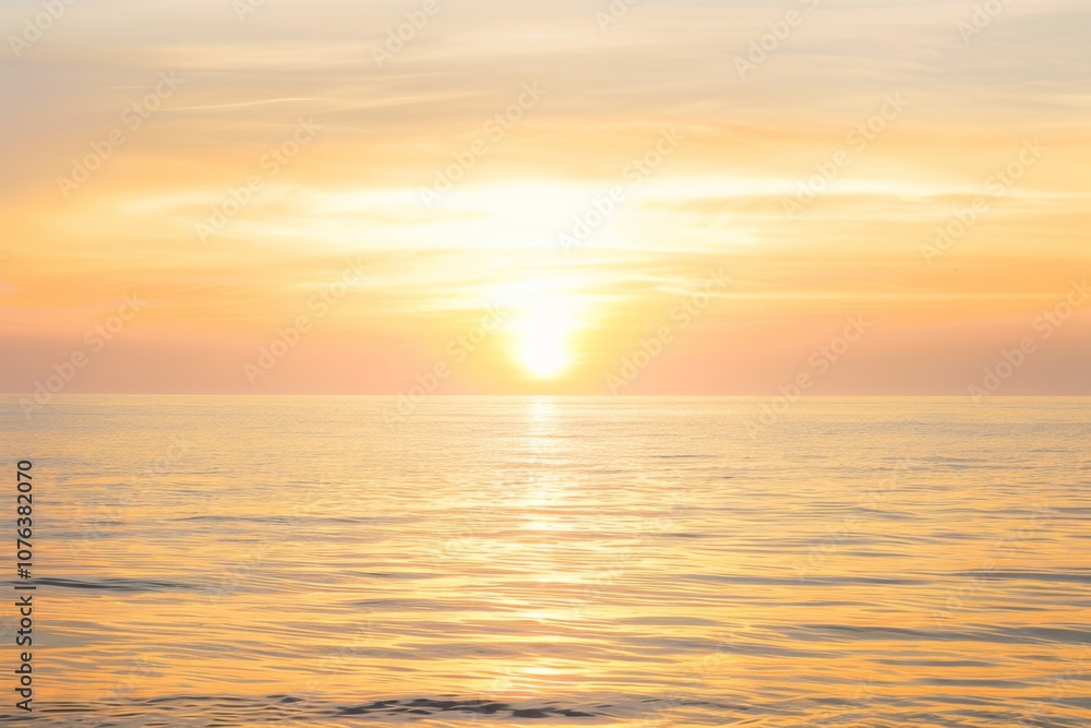 As dawn breaks, the calm sea reflects the brilliant orange hues of the rising sun, creating a serene atmosphere filled with warmth and beauty. The horizon glows softly.