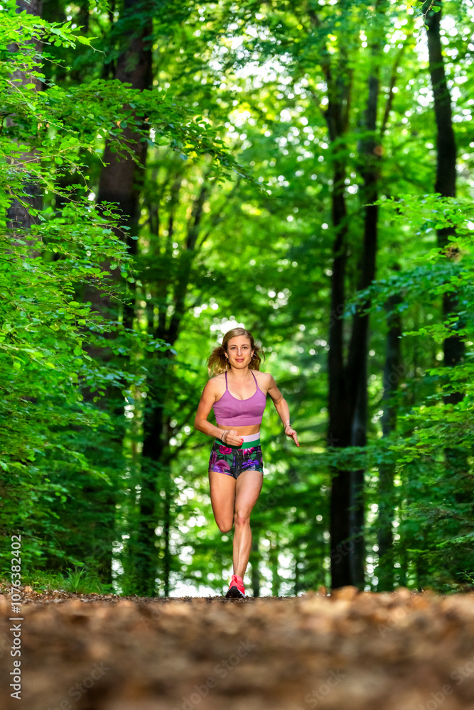 Beautiful athlete running in forest Beautiful athlete running in forest