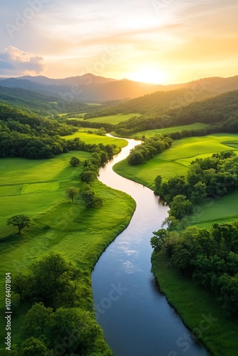 Sunset Over Serene River Winding Through Lush Green Landscape and Rolling Hills