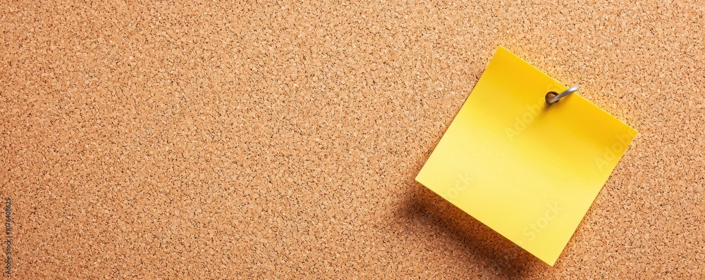 A bright yellow sticky note pinned to a corkboard, displaying a minimalist office setup, ideal for reminders and organization. A bright yellow sticky note pinned to a corkboard, displaying a minimalist office setup, ideal for reminders and organization.