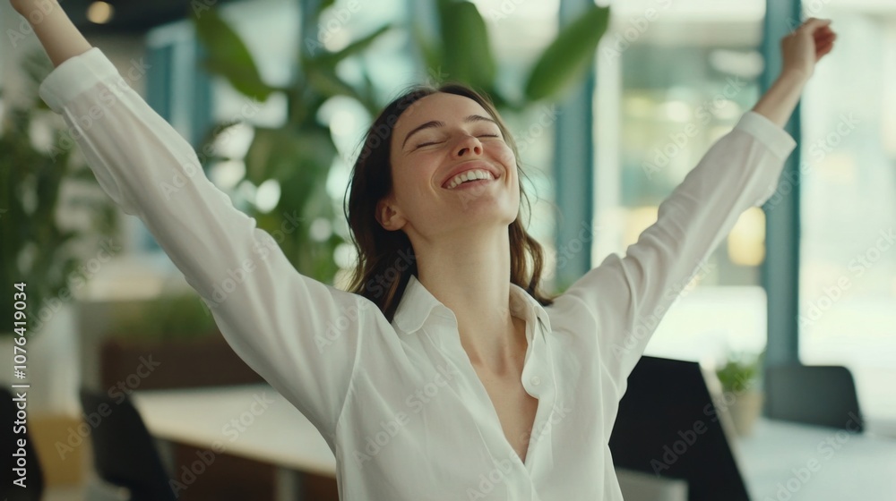 Fototapeta premium Office worker taking a break to do stretches in a modern office setting, promoting work-life balance and physical well-being in the workplace.
