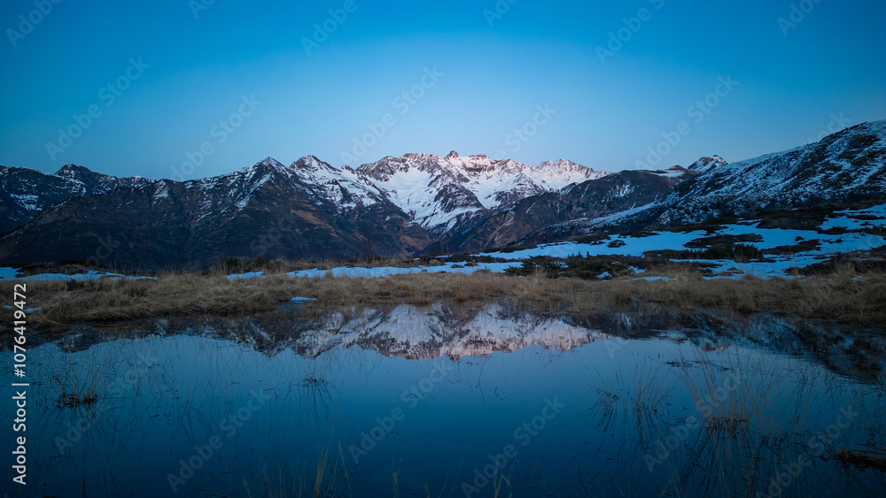 Sunset over the Pyrenees mountains with the reflection of the peaks in the water of the lake High quality 4k footage Sunset over the Pyrenees mountains with the reflection of the peaks in the water of the lake High quality 4k footage