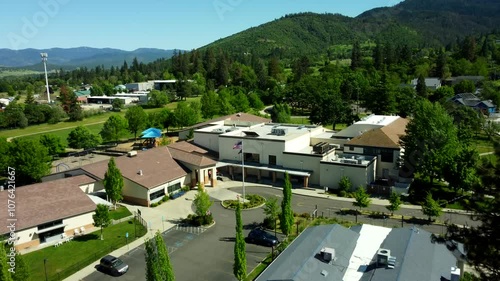 USA, OR, Ashland, Bellview School and Bellview Grange, 2024-05-14 - The main building with the original library is on the right. Also playground and track and field, with a 5G Cell Tower. photo