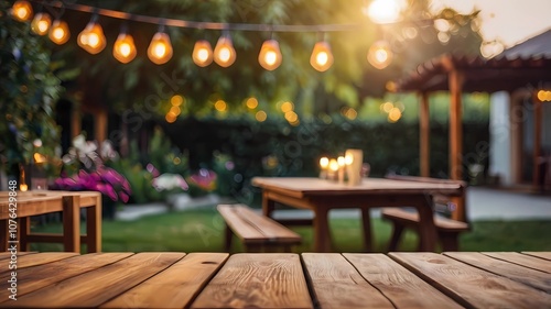 Empty wooden table with party in backyard, blurred background with festive bunting